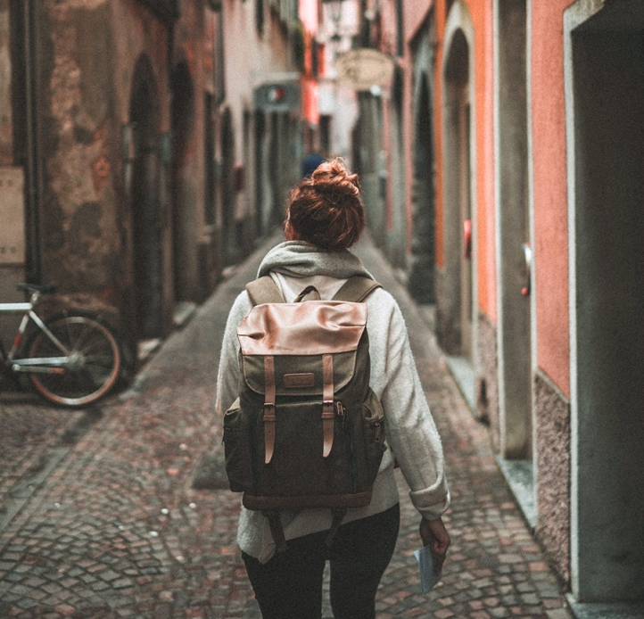 Student with a backpack, walking down a European street